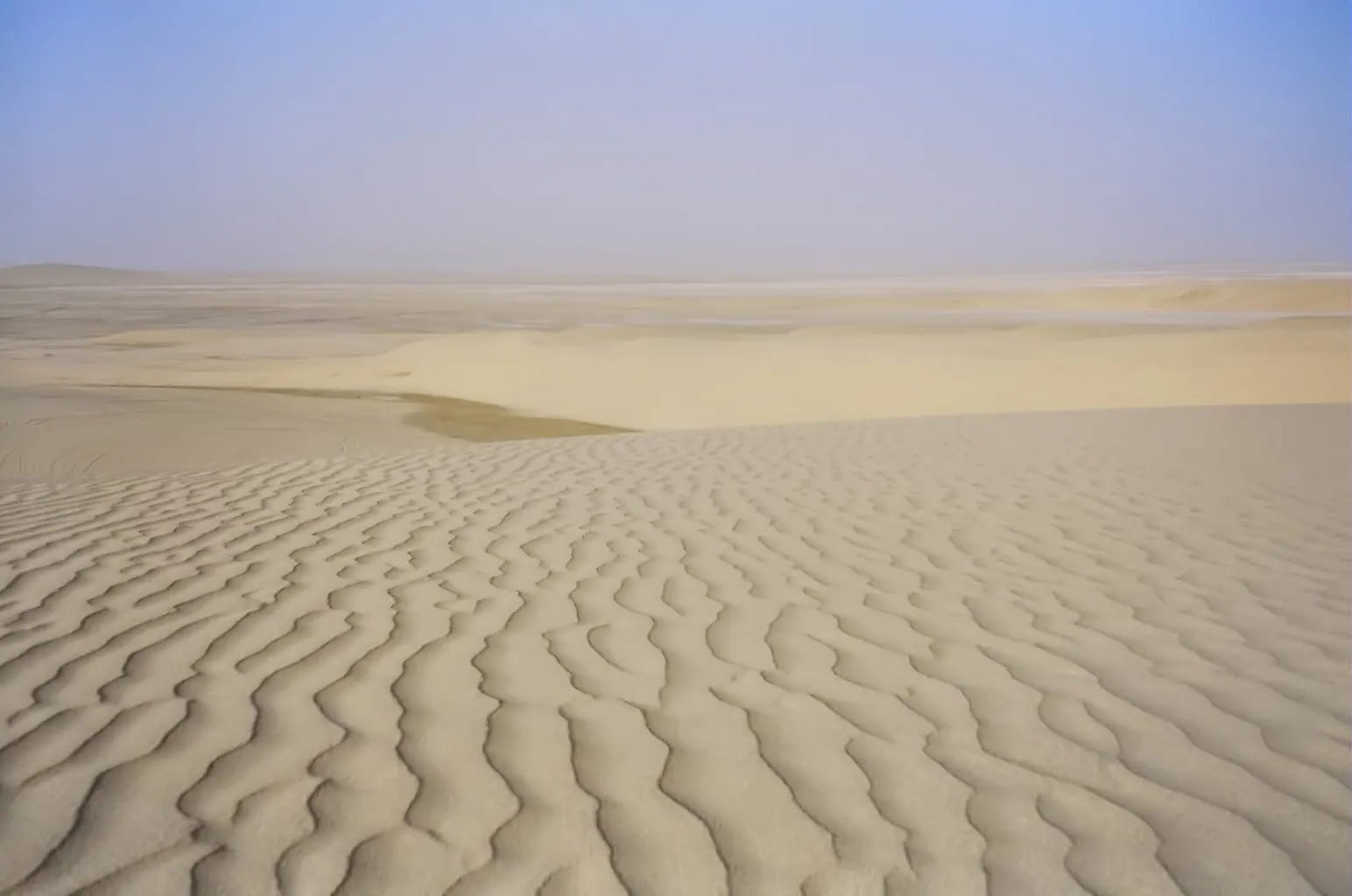 Golden sand dunes in the Qatar desert