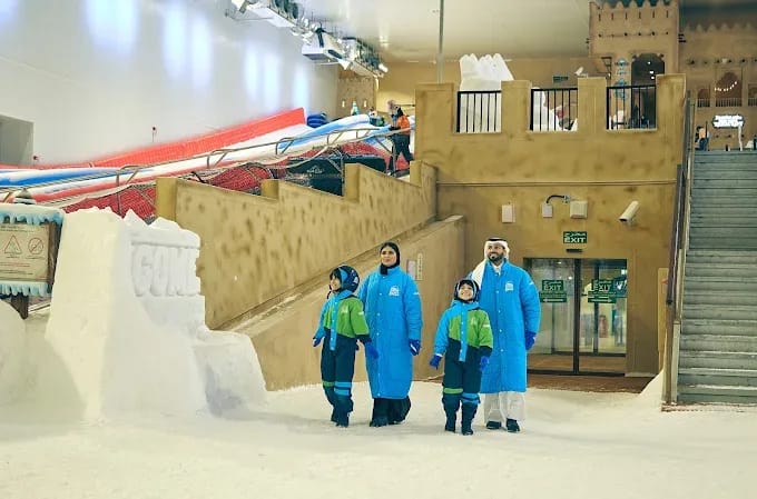 Family playing in the snow at Snow Dunes Qatar